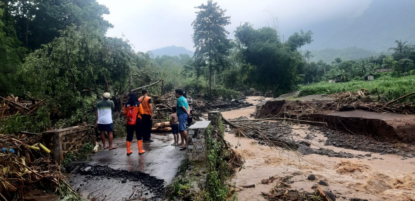 Anggota BPBD Situbondo saat meninjau jembatan yang putus akibat diterjang banjir bandang beberapa hari yang lalu. (Foto: BPBD Situbondo)