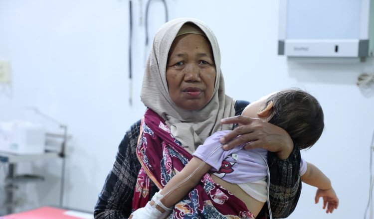 Seorang ibu menggendong anaknya yang keracunan MBG. (Foto: Dok/Diskominfo Jember - ZONA INDONESIA)